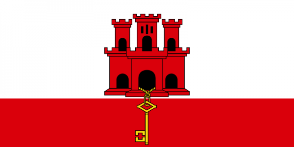 Czerwony zamek z trzema wieżami stojący na czerwonym prostokącie z wystającym dużym żółtym kluczem z wyjścia zamku