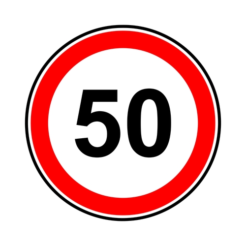 Znak drogowy ograniczenie prędkości do 50 z czerwoną obwódką białym tłem i czarną liczbą 50